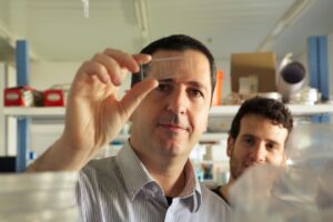 Dr Yaakov Nahmias in a lab with a chip